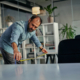 Man measuring distance between office tables